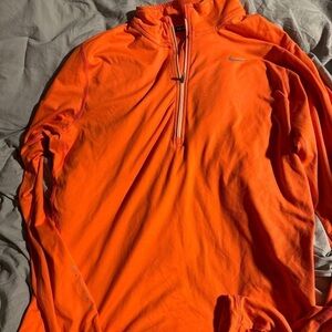 Woman’s orange Nike pull over